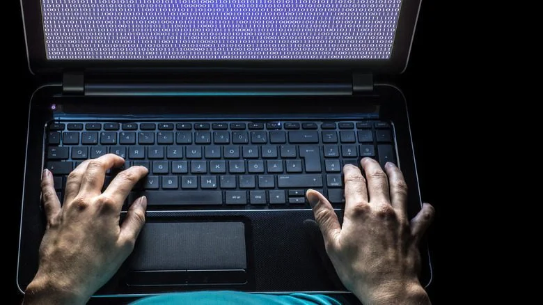 Above view of laptop and hands
