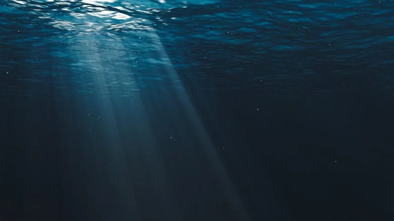 Rayon de soleil perçant la surface sombre de l'océan