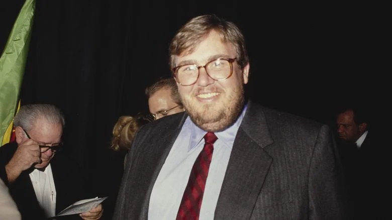 John Candy souriant avec des lunettes