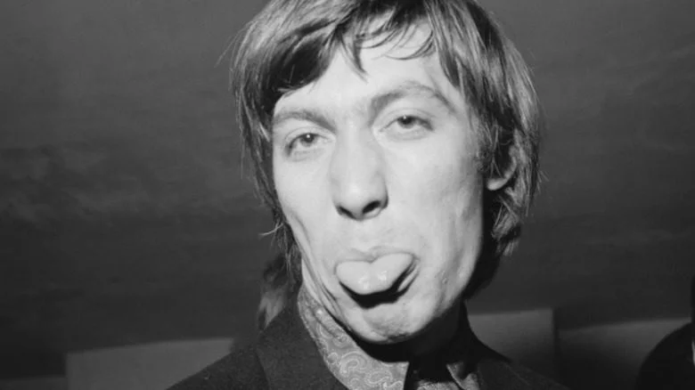 Charlie Watts tirant la langue, en noir et blanc