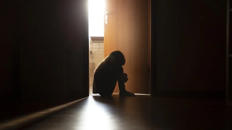 silhouette of crouched child