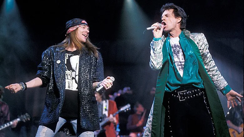 Axl Rose and Mick Jagger on stage singing