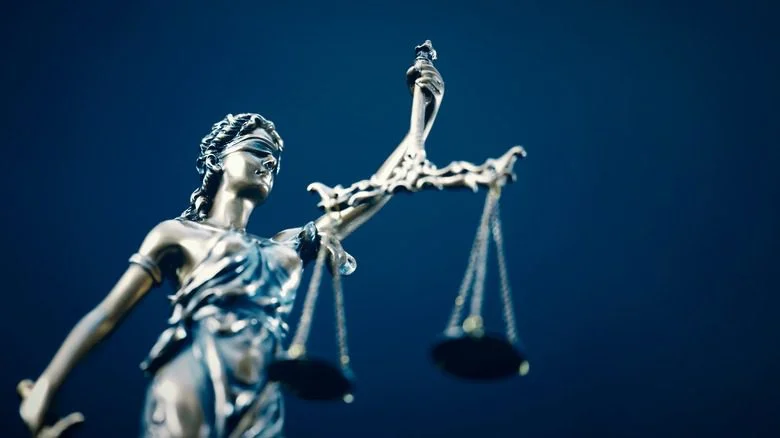 Justice lifting her scales