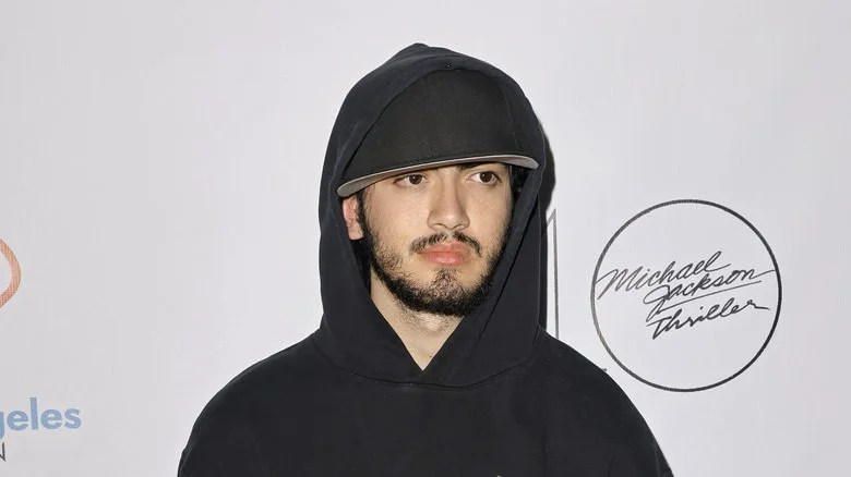Bigi Jackson avec une casquette de baseball et un capuchon