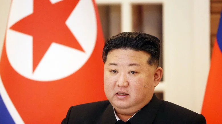 Kim Jong-un devant un drapeau nord-coréen