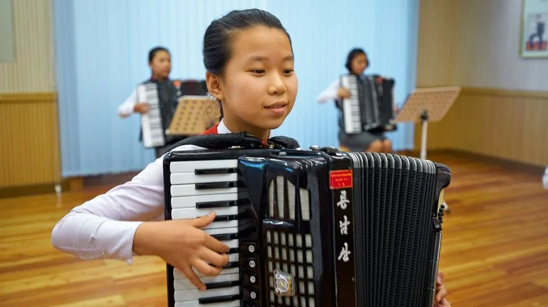 Enfants nord-coréens apprenant à jouer de l'accordéon