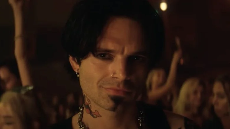 Sebastian Stan as Tommy Lee smirking