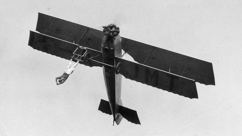 Homme suspendu d'un avion