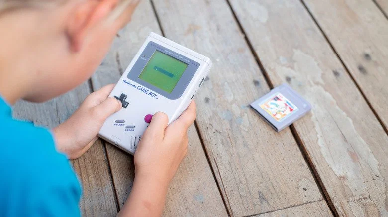Un enfant jouant avec un Nintendo Game Boy
