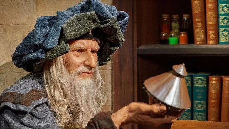 Statue de Nostradamus tenant un objet ressemblant à un OVNI