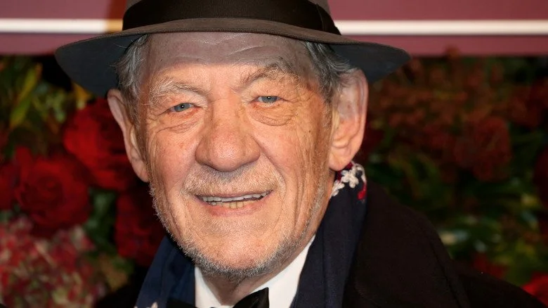 Ian McKellen smiles from under fedora
