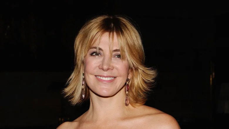 Natasha Richardson smiling blond hair dark background