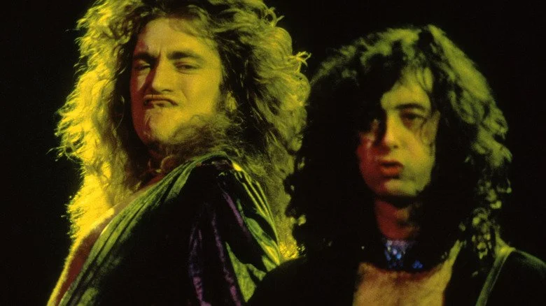 Robert Plant faisant une grimace pendant que Jimmy Page joue de la guitare lors d'un concert de Led Zeppelin