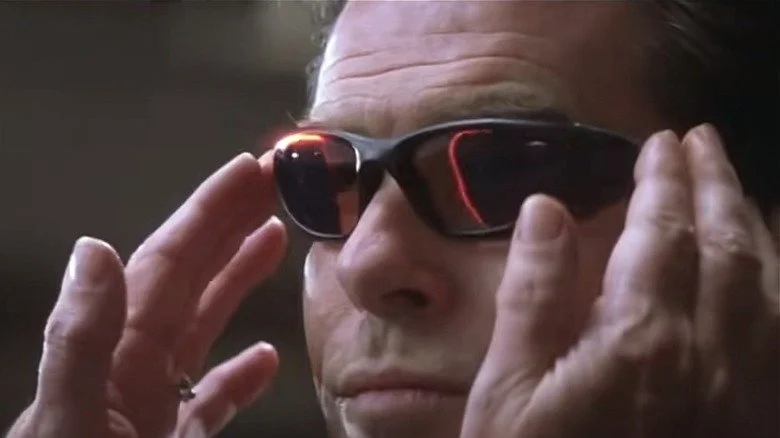 Pierce Brosnan as James Bond wearing glasses