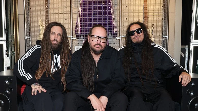 Brian Welch, Jonathan Davis, and James Shaffer posing at an adidas event in 2024