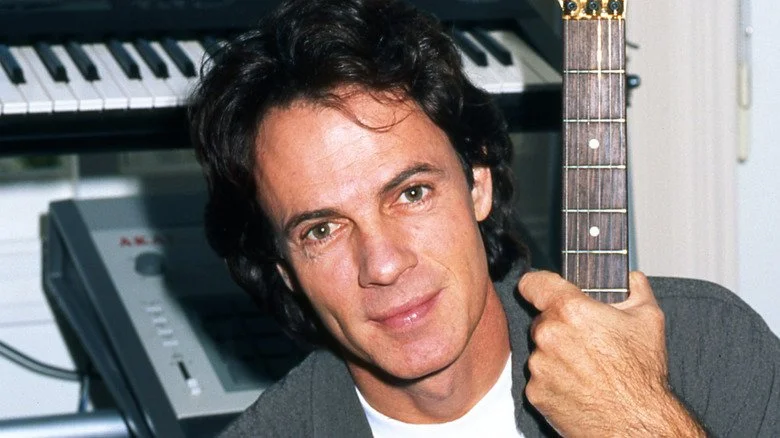 Rick Springfield hugging guitar