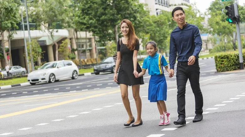 Famille avec un enfant marchant dans la rue à Singapour