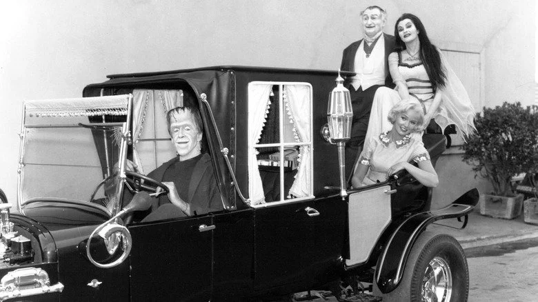 Munsters cast posing in car