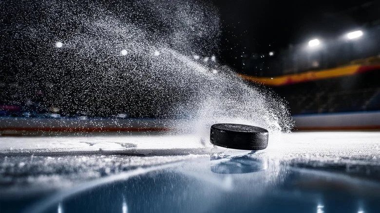 Hockey puck sliding on ice