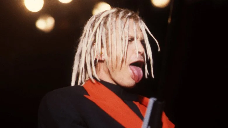 Billy Idol sticks tongue out and wears dreadlocks during cyberpunk concert