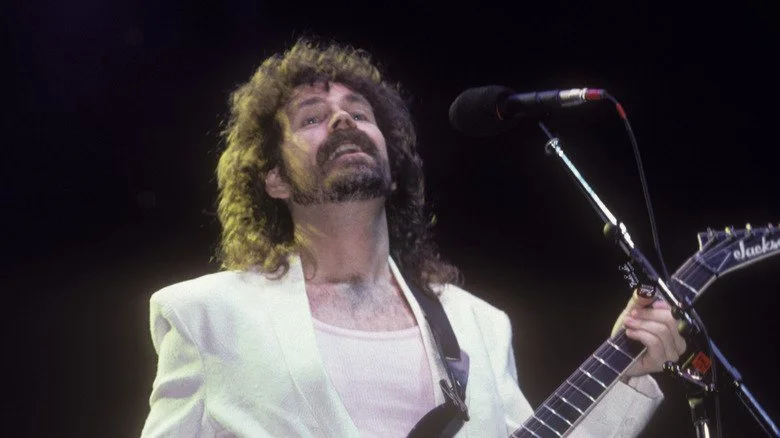 Brad Delp of Boston performs in white suit in 1980s