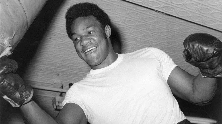 Un jeune George Foreman frappant un sac de frappe