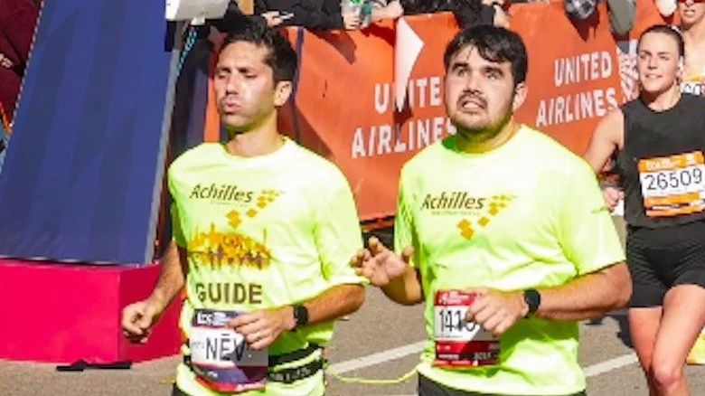 Nev Schulman running as a guide in the NYC Marathon