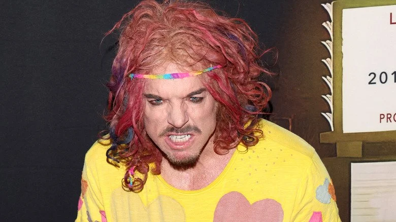 Carrot Top gritting teeth in rainbow headband