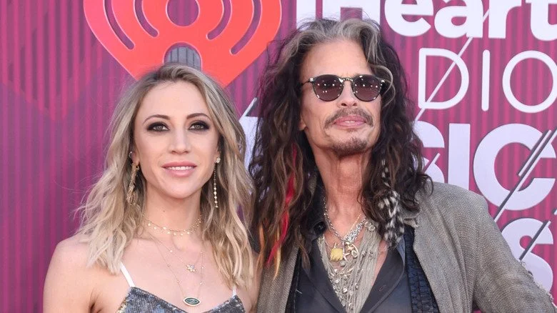 Steven Tyler looking out proudly with Aimee Ann Preston smiling into camera