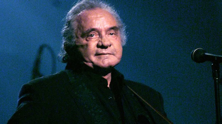 Johnny Cash staring out while on stage