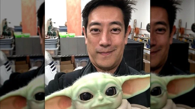 Grant Imahara holds his Baby Yoda robot