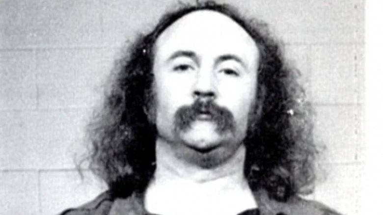 David Crosby staring ahead in mugshot