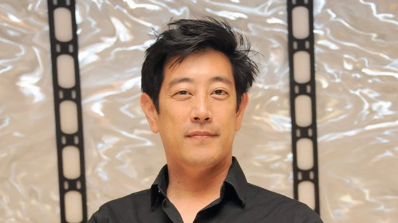 Grant Imahara souriant légèrement en regardant la caméra