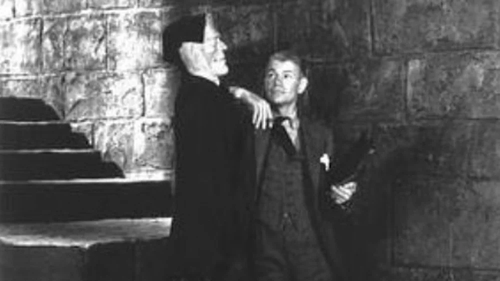 James Whale posing with a model of Frankenstein's Monster