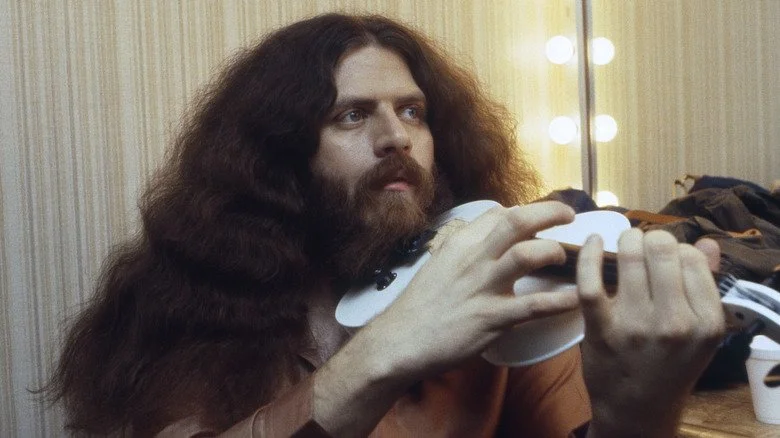 Kansas' Robby Steinhardt holding his violin in dressing room