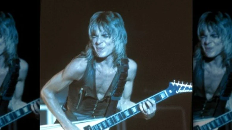 Randy Rhoads playing guitar on stage making guitar face
