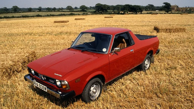 Red 1981 Subaru BRAT in a cornfield