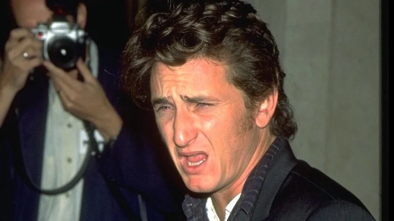 Sean Penn yelling in front of a photographer