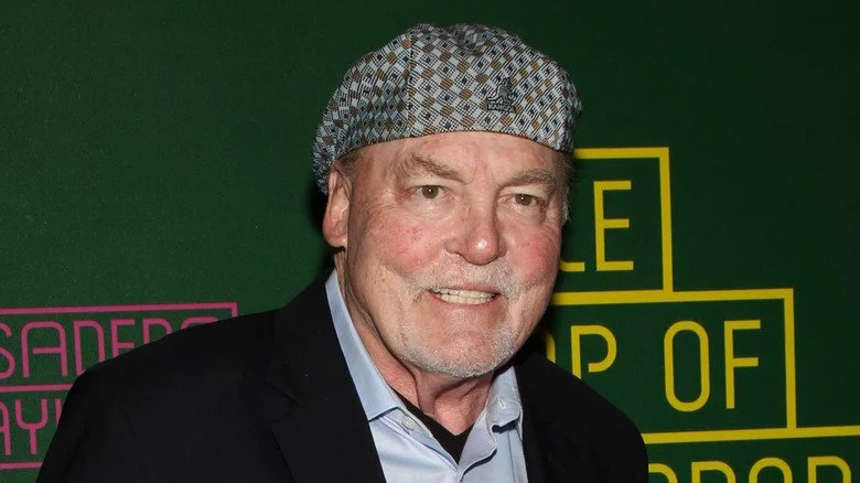 Stacy Keach wincing in cap