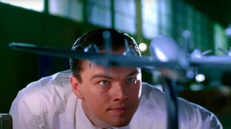 Leonardo DiCaprio as Howard Hughes looking at model plane in The Aviator