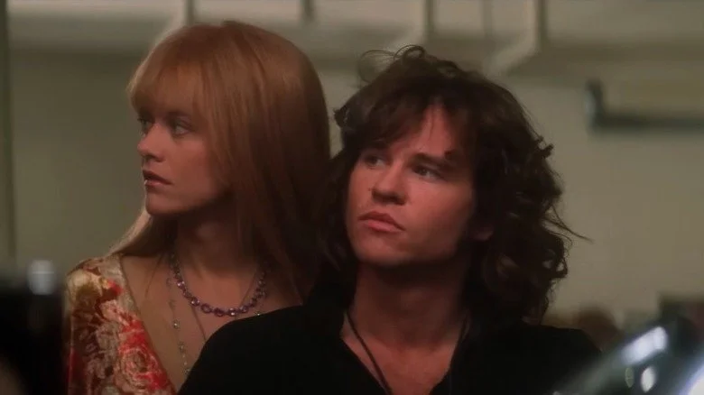 Meg Ryan and Val Kilmer looking sullen in scene from The Doors