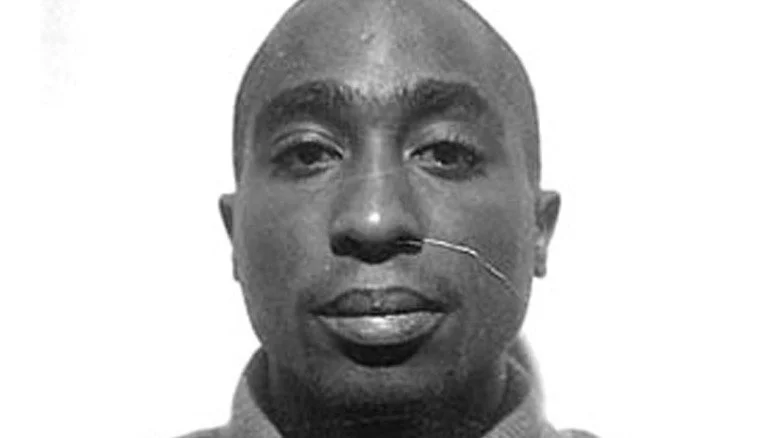 Tupac Shakur stares ahead in mugshot