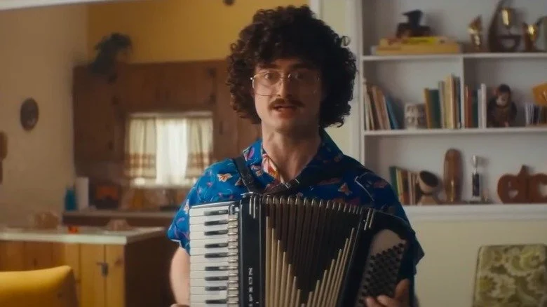 Daniel Radcliffe playing accordian as 'Weird Al' Yankovic in a scene from Weird