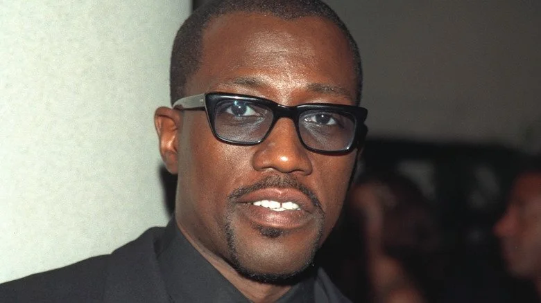 Wesley Snipes with dark glasses looking into camera in '90s