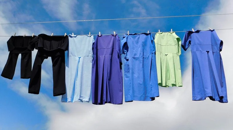 Amish dresses and pants drying on a clothesline