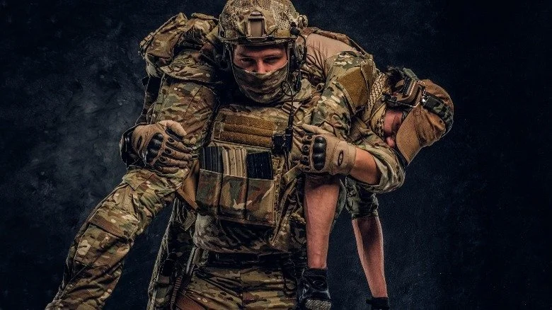 Soldat portant un camarade blessé