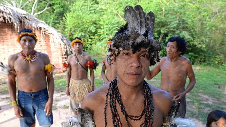 Un groupe d'Awá en tenue traditionnelle dans leur village