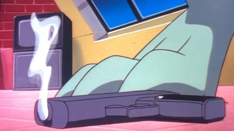 Le pied de Broadway à côté d'un pistolet fumant posé au sol