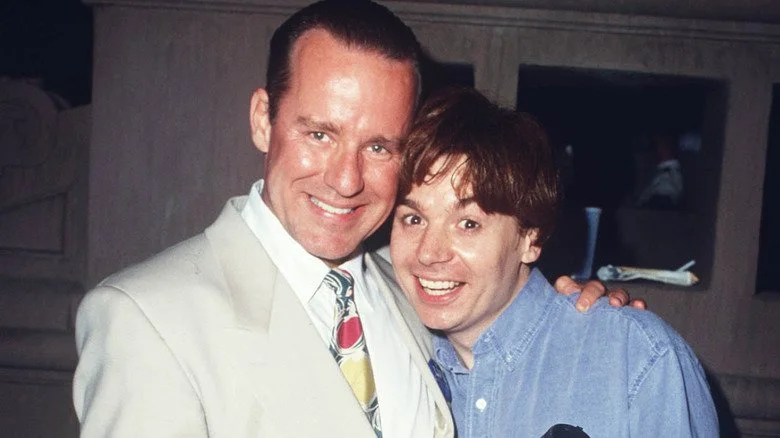 Phil Hartman et Mike Myers souriant et s'enlaçant