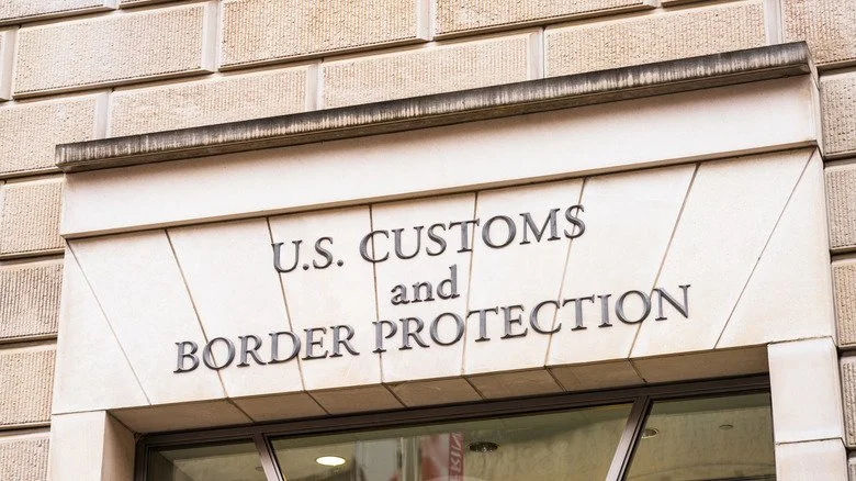 Inscription en pierre U.S. Customs and Border Protection devant un bâtiment ICE